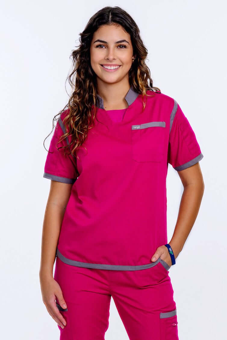 Women's Raspberry Pink Scrub Top with gray trim, offering comfort and style in a professional healthcare setting.