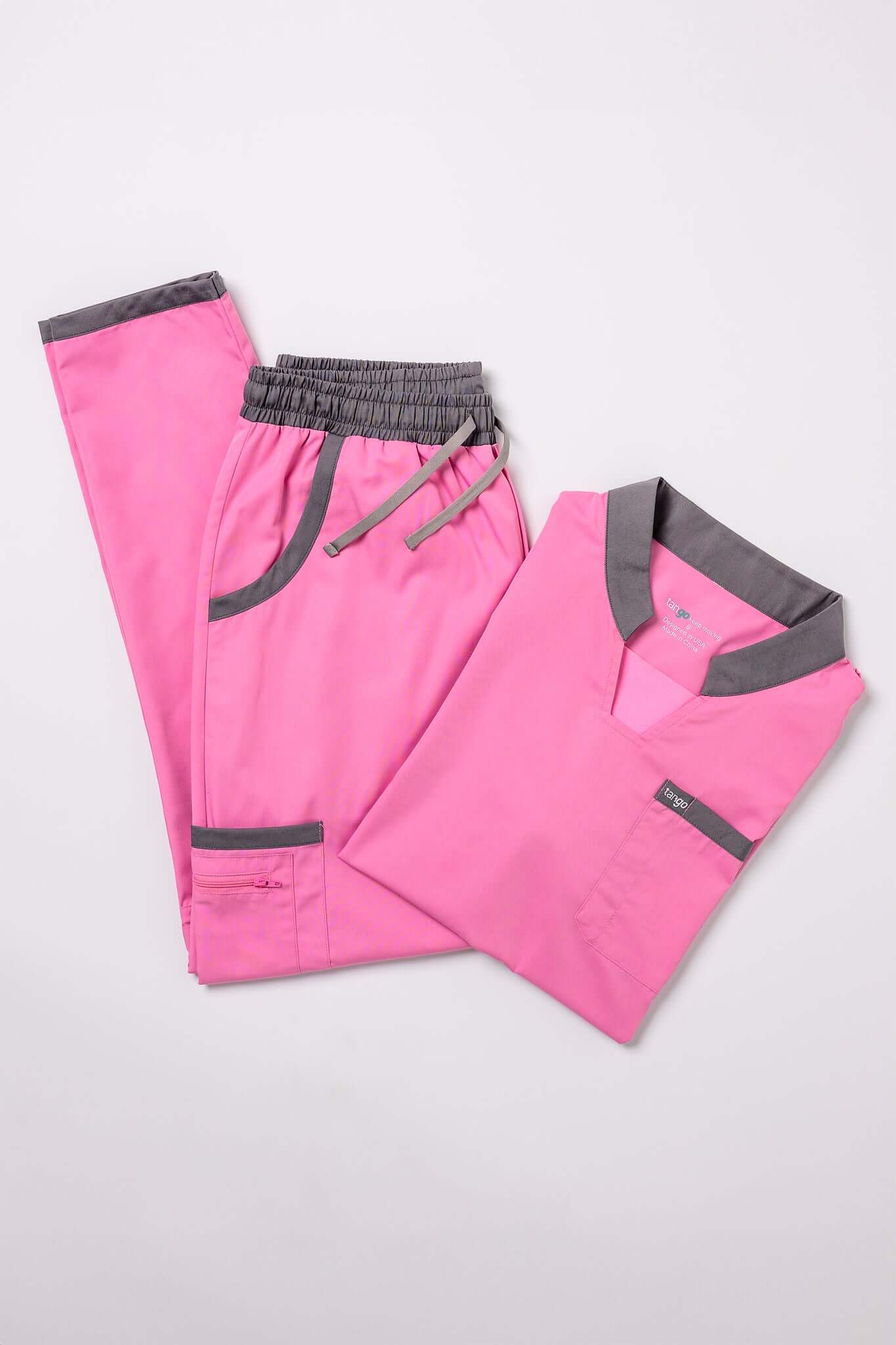 Rose pink scrub top and pants set featuring gray accents for stylish, professional workwear. Ideal for comfort and breathability.