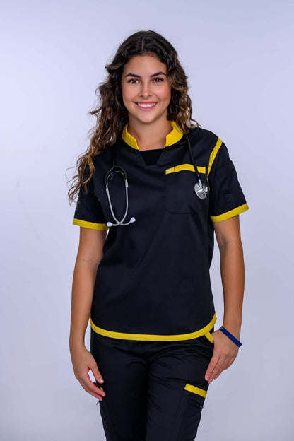 Woman wearing Jet Black and Yellow TangoScrubs scrub pants with stethoscope, smiling, showcasing modern medical uniform style